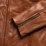 Close-up of zippered pocket on men's vintage brown genuine leather jacket