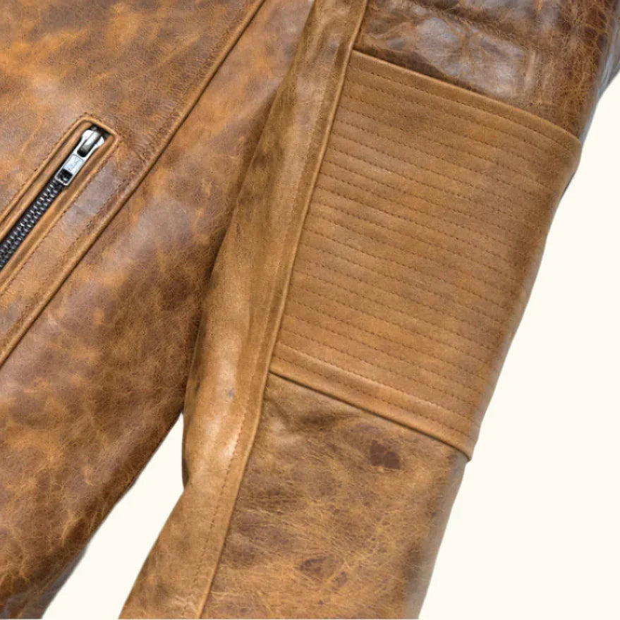 Arm view of the SOVR Leather distressed brown café racer leather jacket featuring premium genuine leather, stand-up snap-tab collar, YKK front zipper, zippered pockets, and a vintage distressed finish.