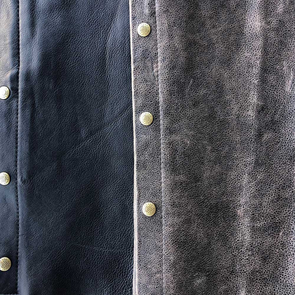 Close-up of horizontal zip chest pocket on men's distressed leather cafe racer jacket
