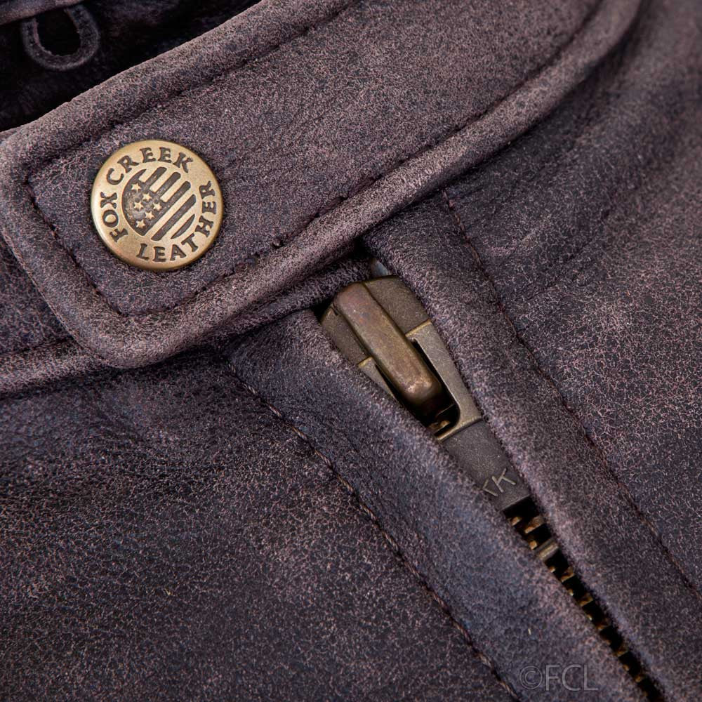 Close-up of snap-tab collar on men's distressed leather cafe racer jacket